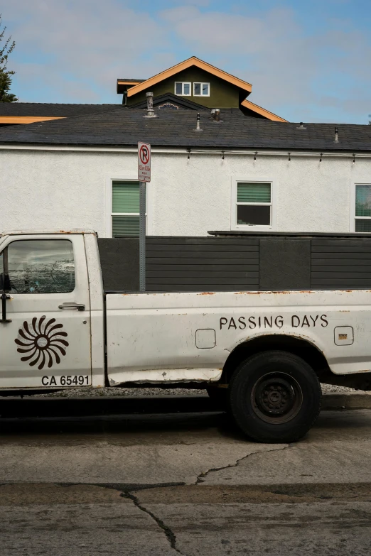 a white truck parked on the side of the street