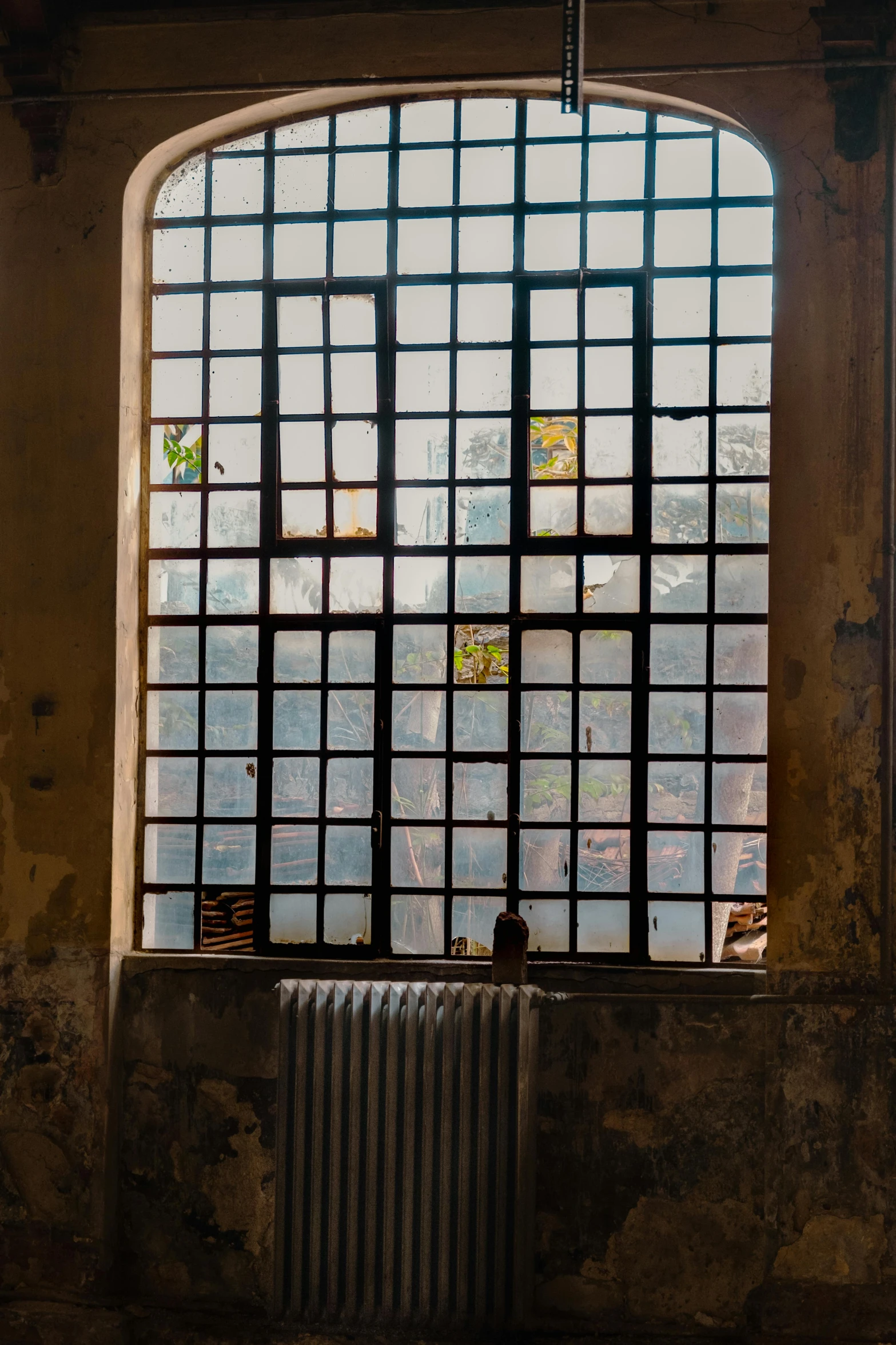 a window with bars and blinds that are open