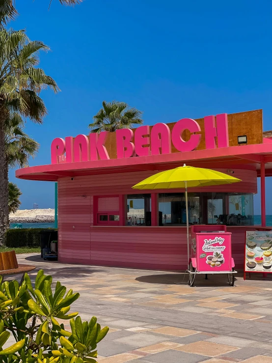 a very colorful beach - side restaurant sits outside