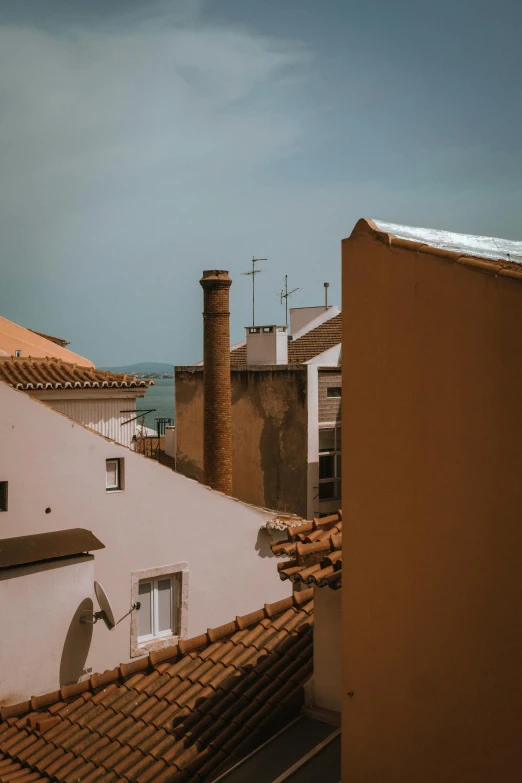 there are some red tiled roofs against a dark blue sky