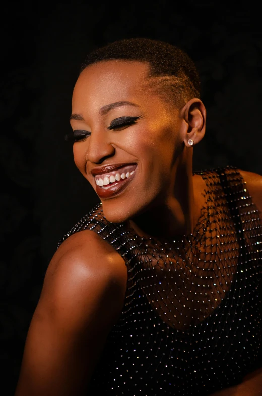 a woman smiling wearing an elegant top and silver jewelry