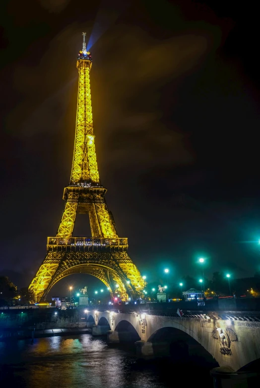 the eiffel tower lit up at night