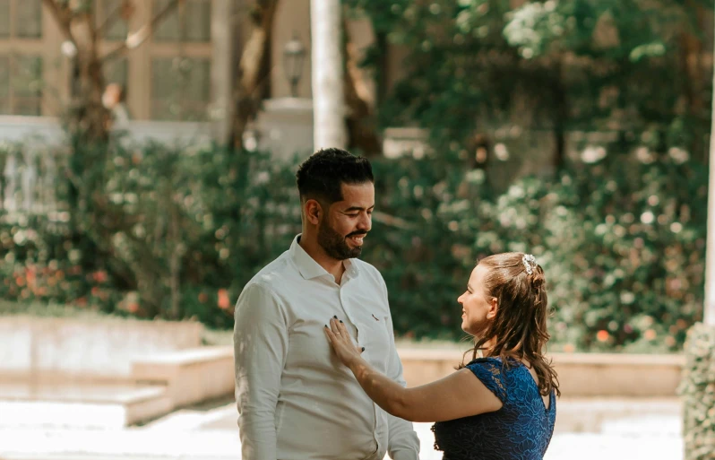 the young woman is trying to help the man dance