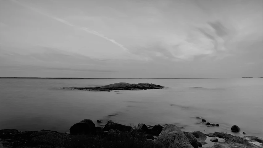 an island with a long beach and sky in the background