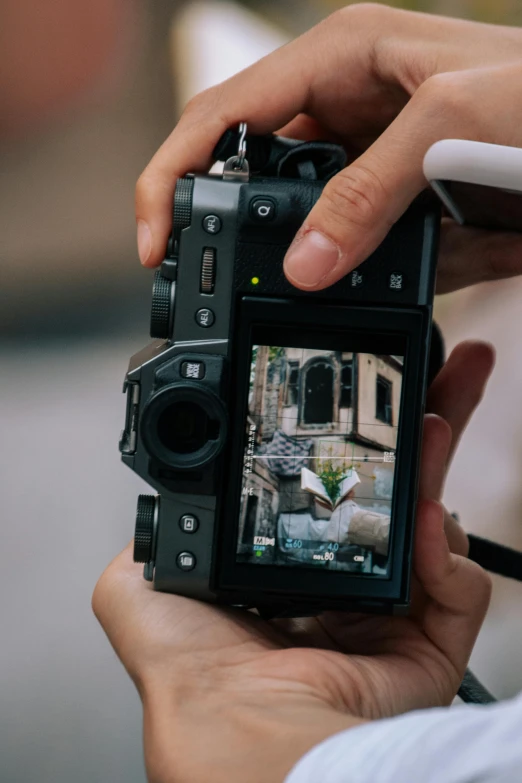 a person holding a video camera in their hand