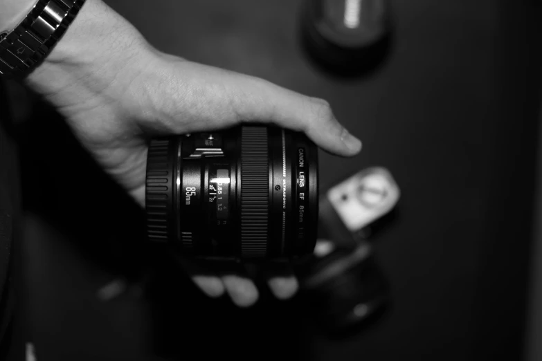 a person holding a camera and some keys