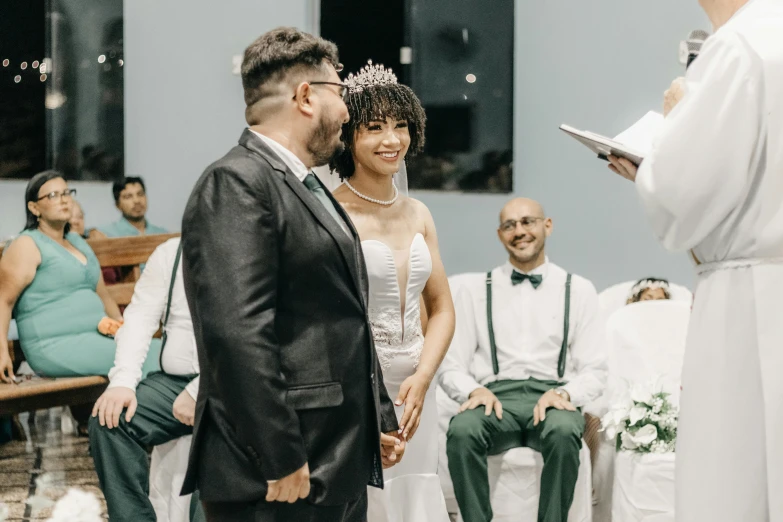 the groom smiles at the bride as she makes her entrance for the ceremony