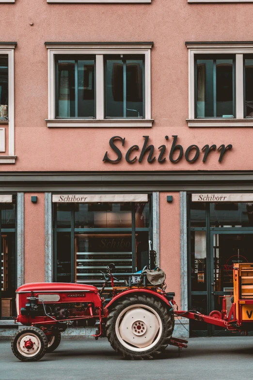 a tractor is parked outside of a store