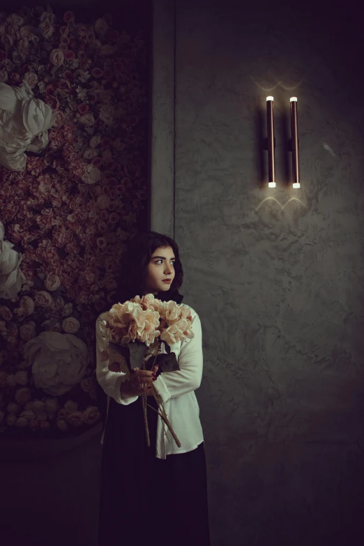 the woman is holding some flowers in her hands