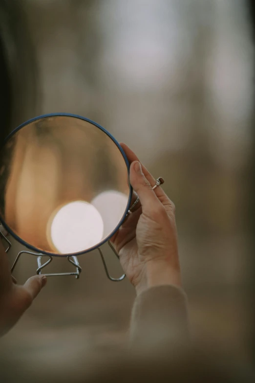 the woman is holding her hands near a mirror