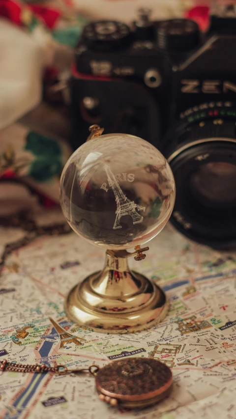 a map is on the table and some camera equipment are around