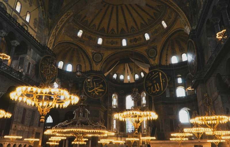 a view of an ornate cathedral with chandeliers and a clock in the center