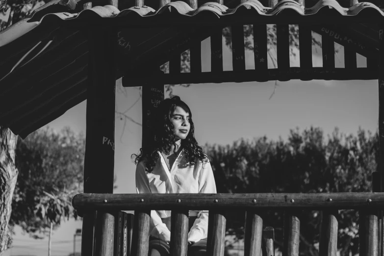 woman sitting on a bench looking at soing outside