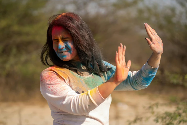 a young woman with a colorful face and body paint