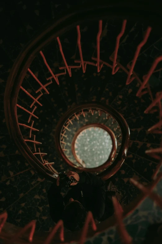 view from bottom of spirally - shaped, metal staircase