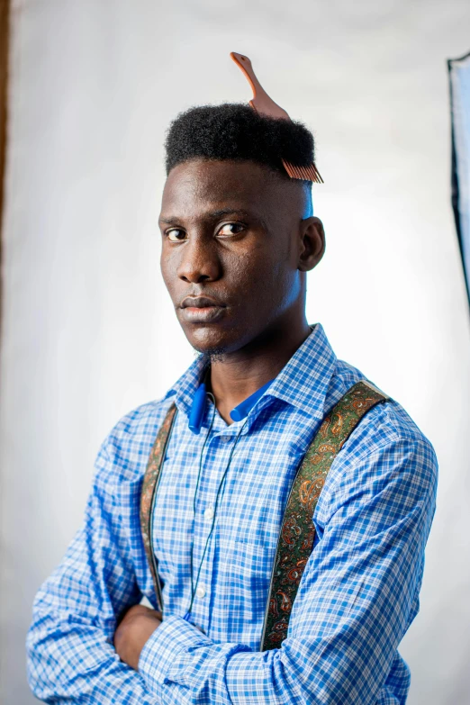 a man wearing a shirt and suspenders looking at the camera