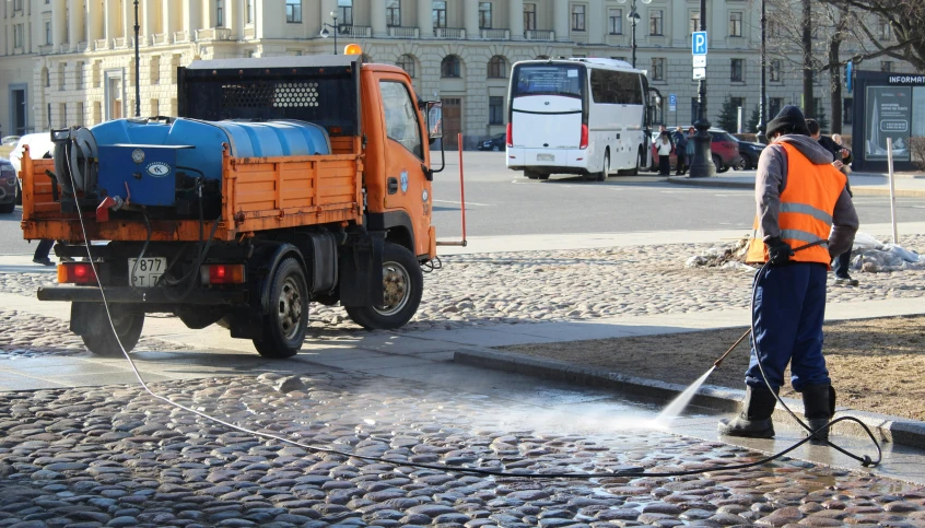 there is a person using a hose to put out a fire