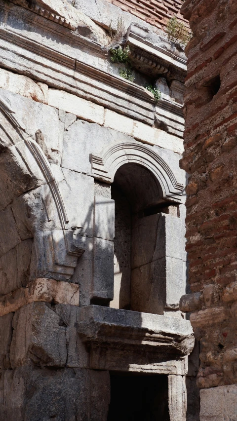 an old wall with stone carving and arches