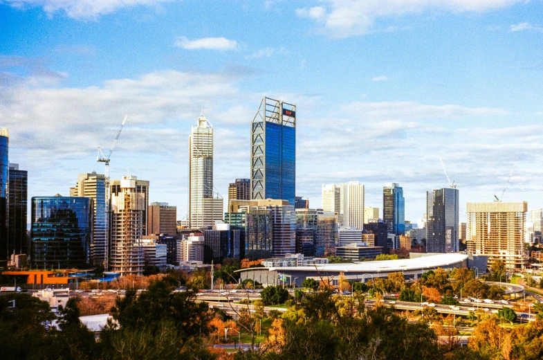 a city is seen with tall buildings on the horizon