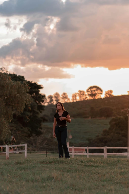 a woman standing in front of a white fence