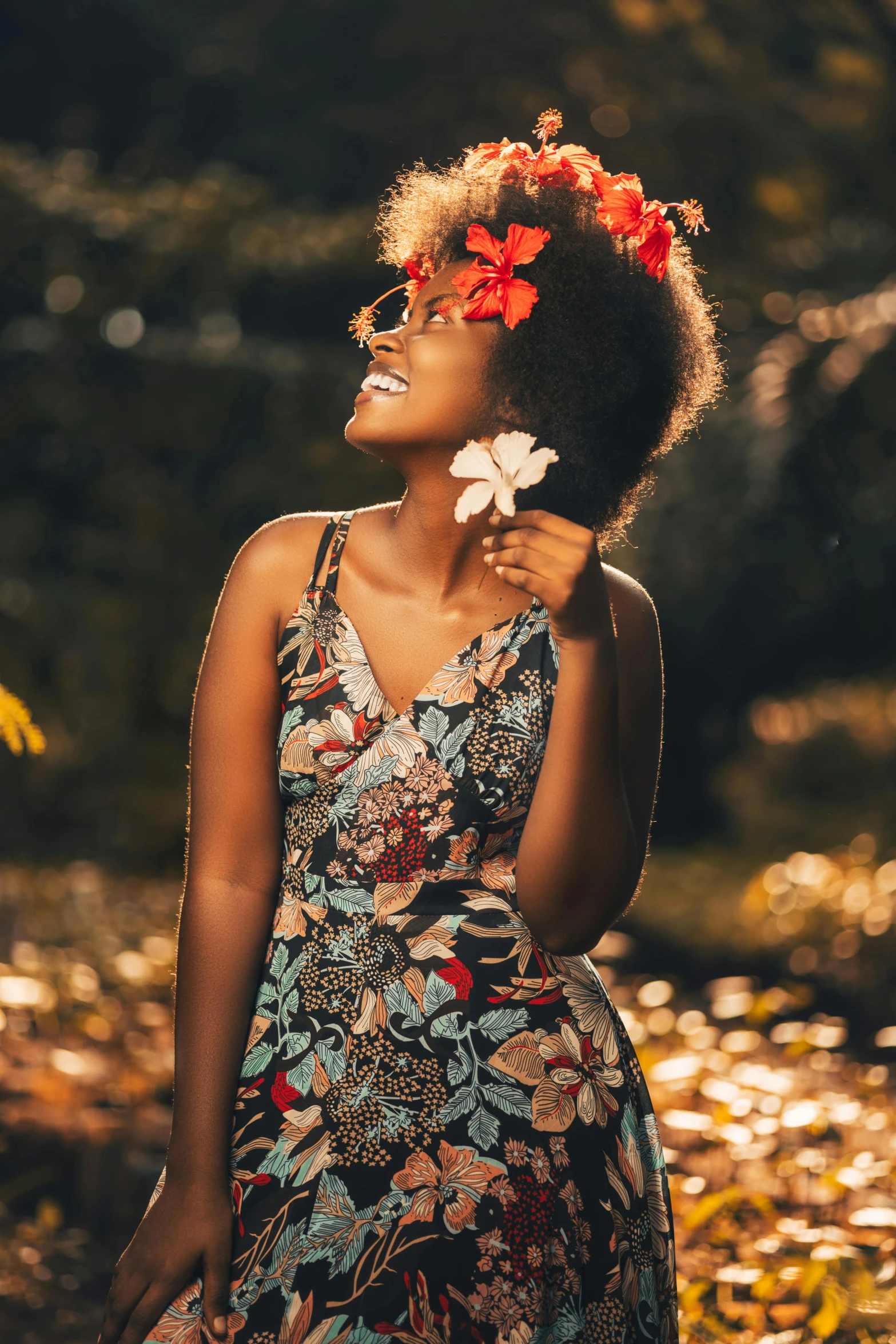 a woman standing in leaves and holding onto flowers