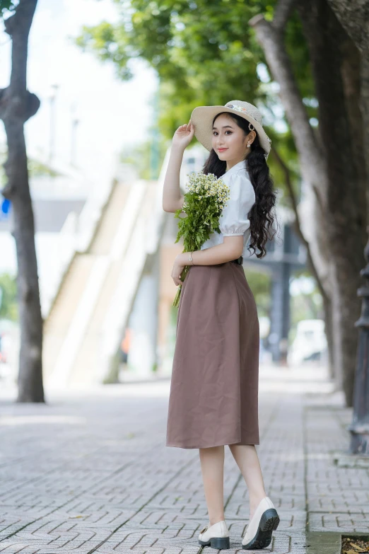 an asian woman is holding flowers and looking at soing