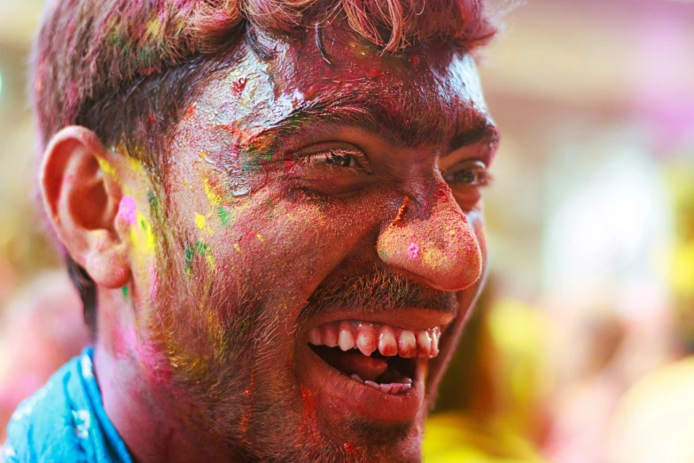 a young man is having painted all over his face