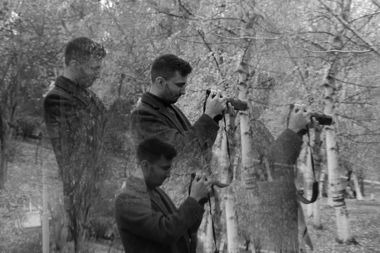 some young people picking up some leaves from trees