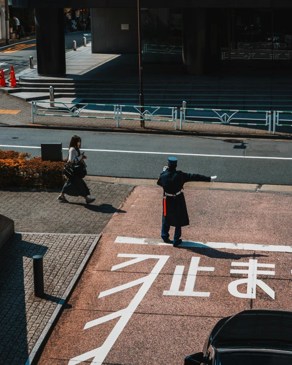 two people walking down the street with one of them holding a staff