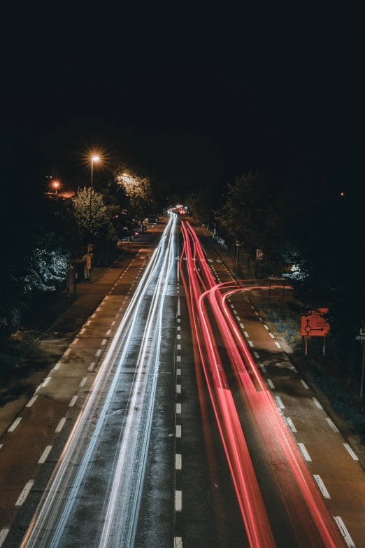 some cars are driving on the road at night time