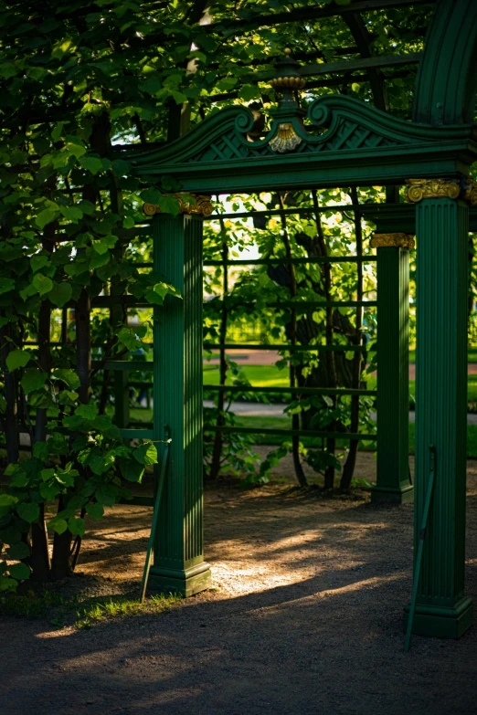 an elaborate archway in the middle of some kind of park