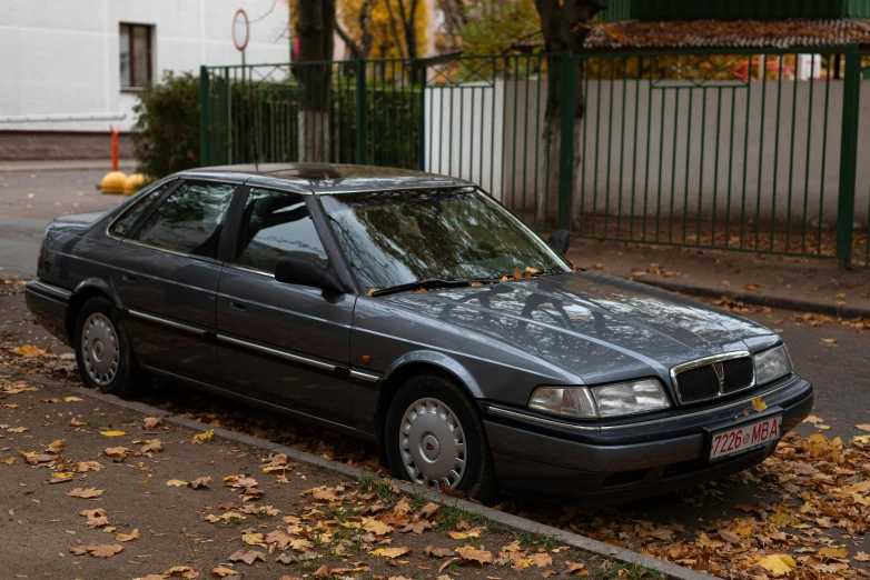 an automobile parked in a residential street on a fall day