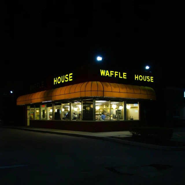 a restaurant with large windows that say waffle house