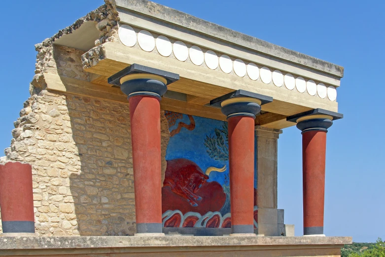 a building that has some pillars and red columns