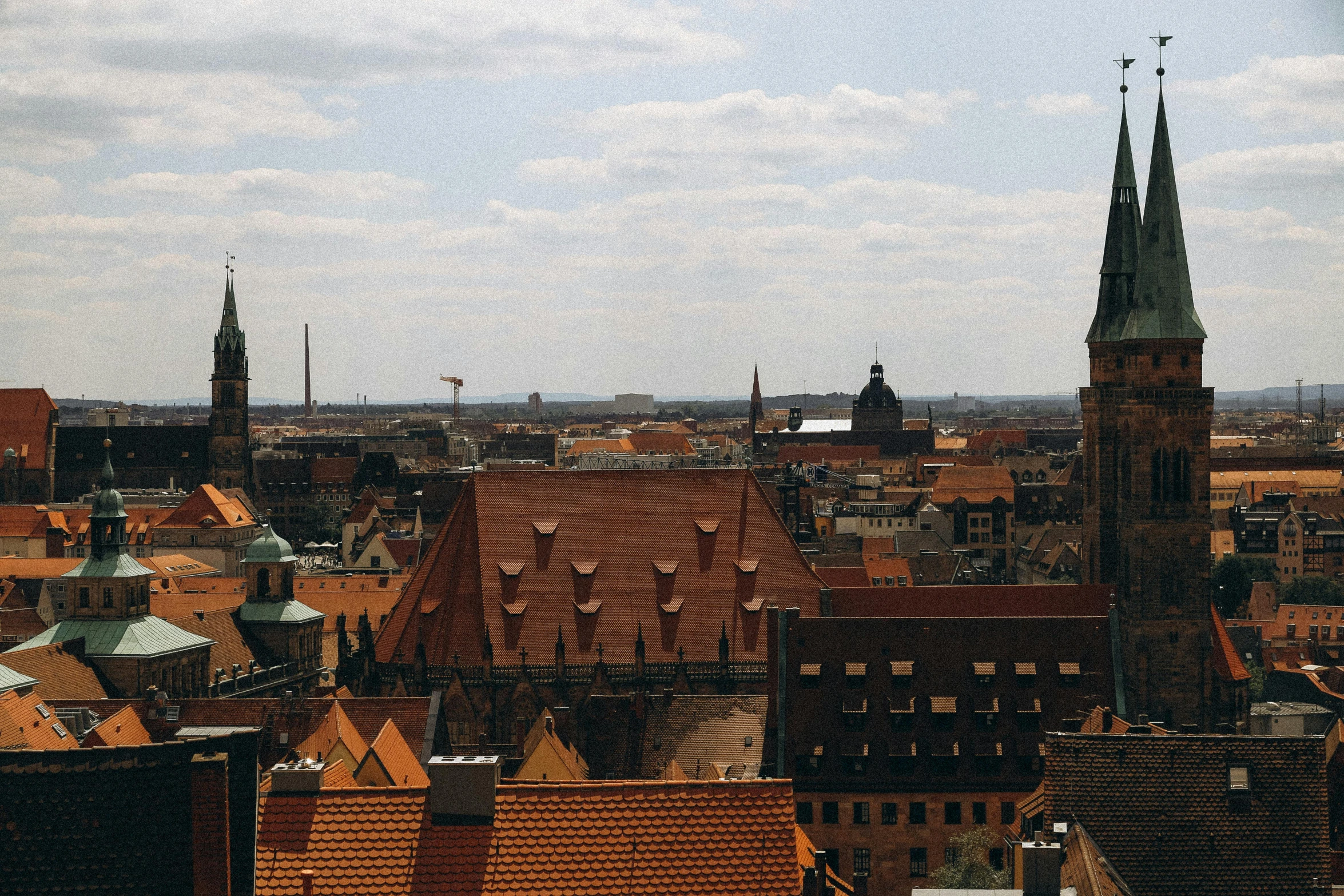 a po taken from a building top in europe looking at a city with tall spires