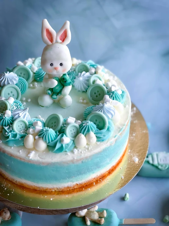 a blue and white cake sitting on top of a table