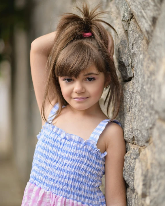 a girl leaning against a rock by herself