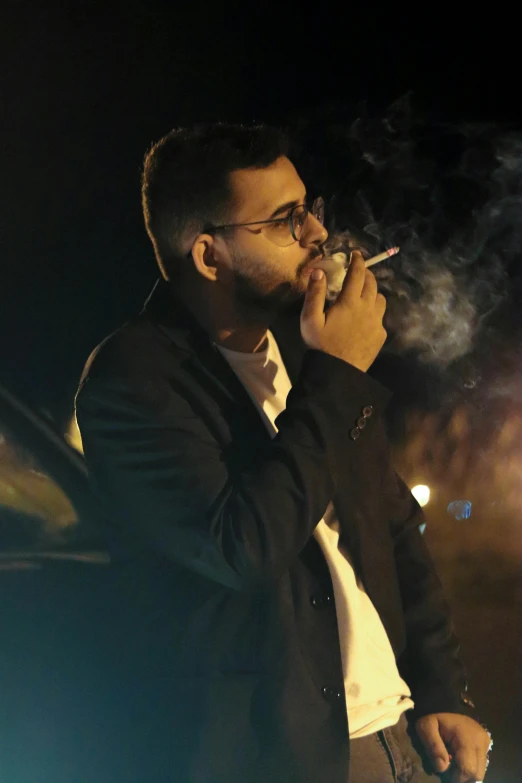 a man with glasses smoking a cigarette and a white shirt