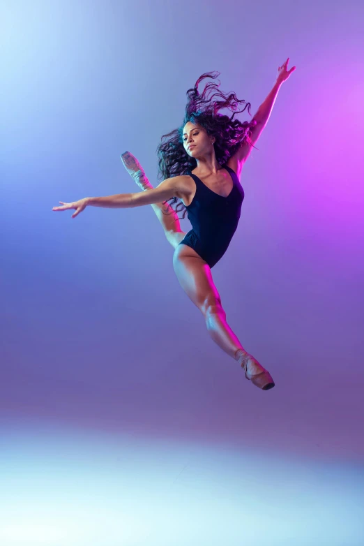 a dancer with colorful lighting in the background