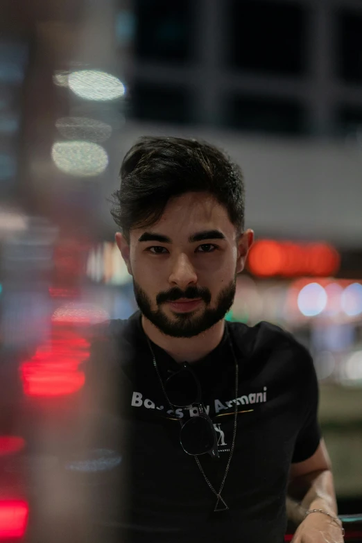 a man sitting in a chair outside during the night