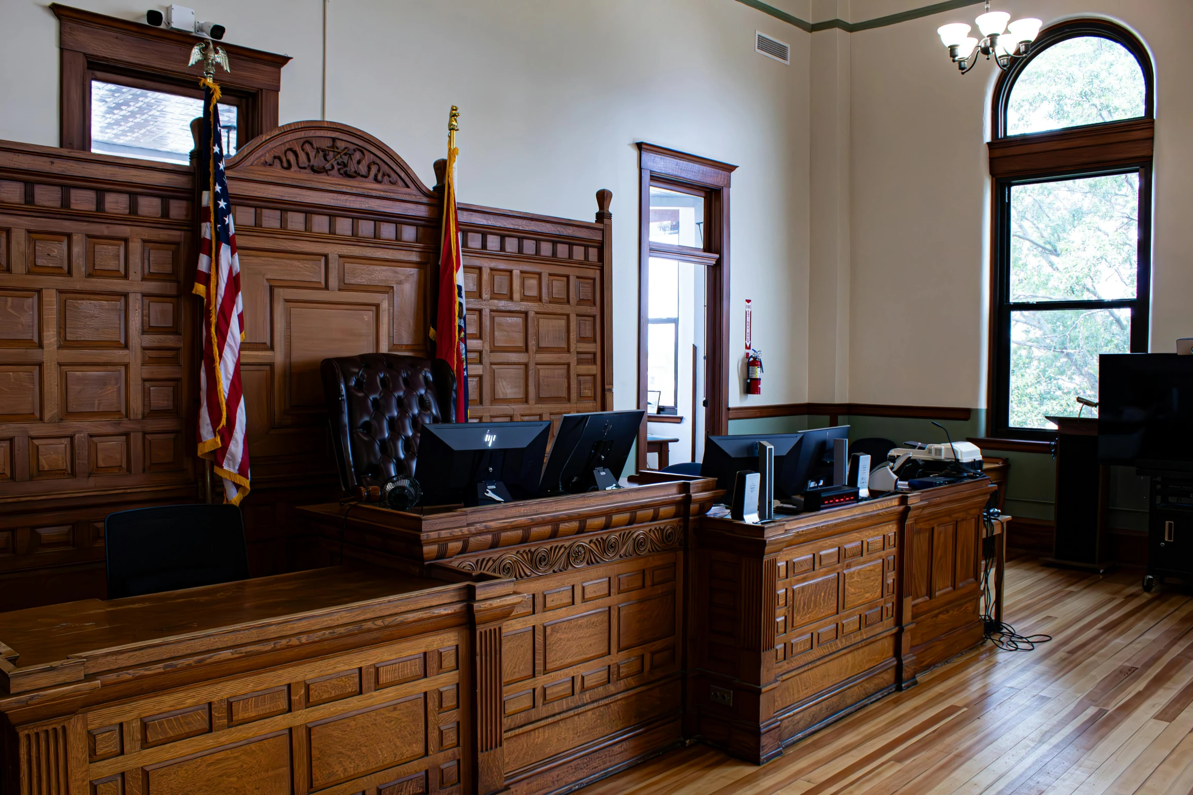 two desks in the front of a wooden room