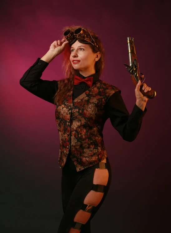 a woman dressed in a top, skirt and bow tie holds two small guns