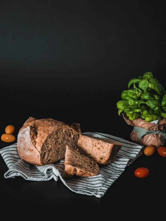 several slices of bread sit on towels near fruit