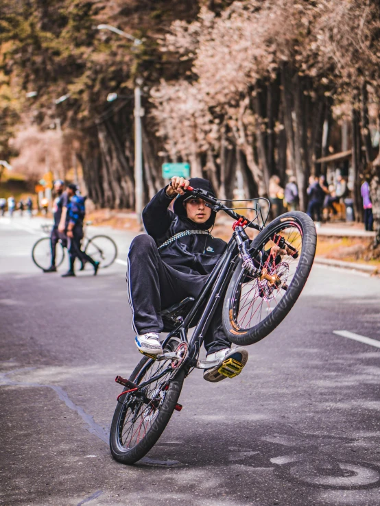 a young man flying through the air while riding a bike