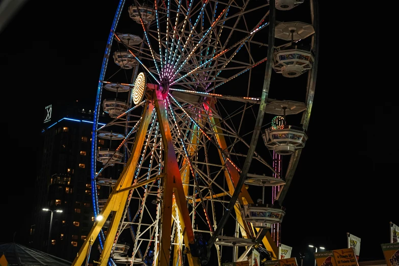 a ferris wheel is lit up at night