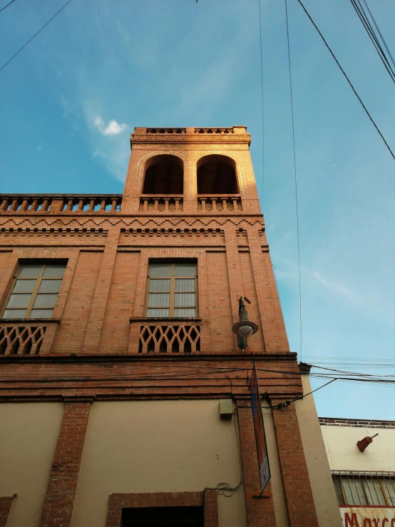 a building with two windows in front of a blue sky