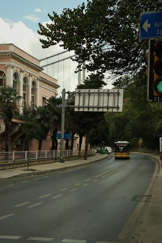 a view down an empty street of a city, with cars in the road