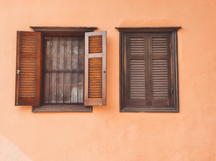 two windows that are on a wall together