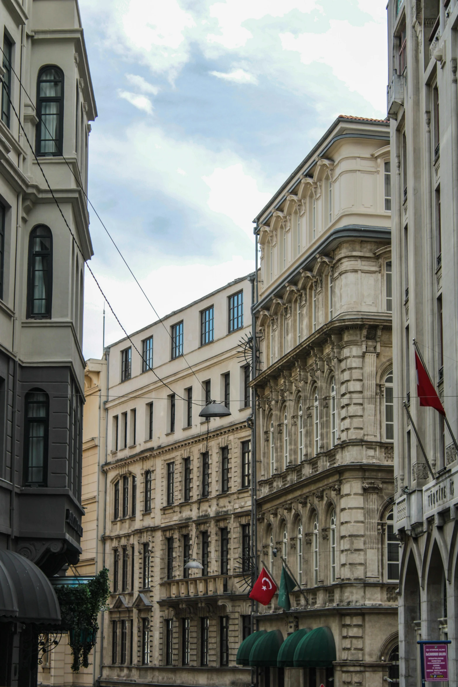 buildings on a city street with a flag in the foreground