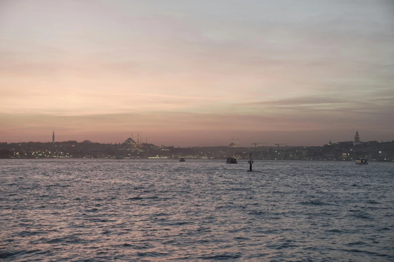 a man paddle boarding through the water on a clear day